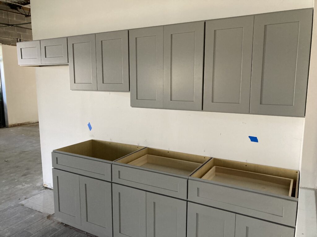 Oak kitchen cabinets with a durable finish, showcasing strength and resistance to scratches and moisture, alongside maple, hickory, and cherry wood options.